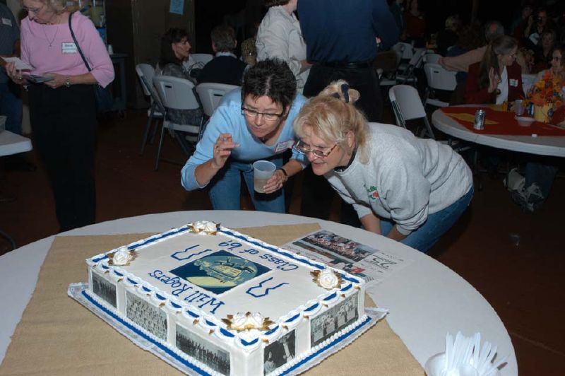 Liz Taylor Pounds and Regina Dunn Dunlap inspect the cake