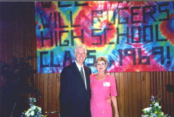 David Zwart and Jane Minor McCoy with flower power banner